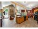 Open kitchen with granite countertops, a breakfast bar and a stone fireplace in the adjacent living area at 1820 Habersham Gate Dr, Cumming, GA 30041