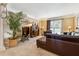 Comfortable living room featuring a plush leather sectional, a glass coffee table and large potted plant at 1820 Habersham Gate Dr, Cumming, GA 30041
