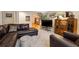 Inviting living room featuring a leather sectional, patterned pillows, and a glass coffee table at 1820 Habersham Gate Dr, Cumming, GA 30041