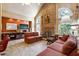 Spacious living room with stone fireplace, vaulted ceiling, and ample natural light at 1820 Habersham Gate Dr, Cumming, GA 30041