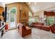 Open concept living room with stone fireplace and views of nature at 1820 Habersham Gate Dr, Cumming, GA 30041