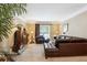 Cozy living room featuring a leather sectional, area rug, and a glass coffee table at 1820 Habersham Gate Dr, Cumming, GA 30041