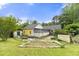 Exterior view of the property showcasing the expansive backyard and screened-in back porch at 4720 Bill Cheek Rd, Auburn, GA 30011