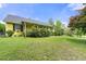 Well-maintained front yard with lush greenery surrounding the charming yellow home at 4720 Bill Cheek Rd, Auburn, GA 30011