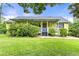 Charming single-story home with a welcoming front porch and lush green lawn at 4720 Bill Cheek Rd, Auburn, GA 30011