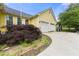 Attached two-car garage with a paved driveway and mature landscaping at 4720 Bill Cheek Rd, Auburn, GA 30011