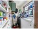 Functional laundry room with shelving, window, and appliances in an organized space at 4720 Bill Cheek Rd, Auburn, GA 30011