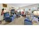 Living room with carpet, a recliner and an eclectic assortment of furniture and decorative items at 4720 Bill Cheek Rd, Auburn, GA 30011