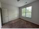 Cozy bedroom with neutral carpeting, a bright window, and a standard door at 545 Tulip Ln, Mcdonough, GA 30252