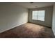 Bright bedroom with neutral carpet and a window providing natural light at 545 Tulip Ln, Mcdonough, GA 30252