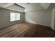Large bedroom featuring tray ceiling, neutral carpeting, and a bright window at 545 Tulip Ln, Mcdonough, GA 30252