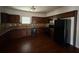 Well-equipped kitchen with dark wood cabinets, granite countertops, and stainless steel appliances at 545 Tulip Ln, Mcdonough, GA 30252