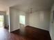 Spacious living room with hardwood floors, chandelier, and open doorway to other rooms at 545 Tulip Ln, Mcdonough, GA 30252