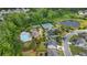 Aerial view of community amenities featuring a swimming pool, tennis courts, playground, and lush landscaping at 6805 Bransford Dr, Cumming, GA 30040