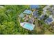 Overhead view showcases community's pool, tennis courts, playground, surrounded by lush greenery and residential homes at 6805 Bransford Dr, Cumming, GA 30040