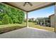 Covered patio area, ideal for outdoor entertaining with a large backyard and green landscaping and blue sky at 6805 Bransford Dr, Cumming, GA 30040