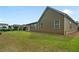 Expansive backyard showcases the house's exterior with multiple windows, a covered patio, and well-maintained lawn at 6805 Bransford Dr, Cumming, GA 30040
