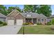 Charming single-Gathering home with stone accents, a two-car garage, and a beautifully landscaped front yard at 6805 Bransford Dr, Cumming, GA 30040