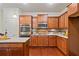 Well-equipped kitchen with stainless steel appliances, granite countertops, and custom wood cabinetry at 6805 Bransford Dr, Cumming, GA 30040