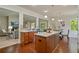 Open concept kitchen with hardwood floors, a center island, and views into the living room at 6805 Bransford Dr, Cumming, GA 30040