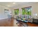 Cozy living room area with hardwood floors, comfortable seating, and bright natural light at 6805 Bransford Dr, Cumming, GA 30040