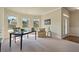 Bright home office space with a desk, chair, and plenty of natural light from three large windows at 6805 Bransford Dr, Cumming, GA 30040