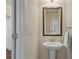 Half bathroom features pedestal sink and traditional fixtures at 6805 Bransford Dr, Cumming, GA 30040