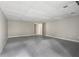 Spacious basement area with carpeting, neutral walls, and ample space for customization at 9438 Cedar Creek Pl, Douglasville, GA 30135