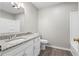 Bathroom features a granite countertop vanity, updated fixtures, and tile flooring at 9438 Cedar Creek Pl, Douglasville, GA 30135