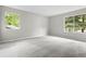 Spacious bedroom with plush carpet and windows overlooking the yard at 9438 Cedar Creek Pl, Douglasville, GA 30135