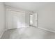 Carpeted bedroom features a closet with bi-fold doors and an open doorway to another room at 9438 Cedar Creek Pl, Douglasville, GA 30135