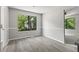 Bright dining room with wainscotting, new paint, and modern gray wood-look flooring with large window view at 9438 Cedar Creek Pl, Douglasville, GA 30135