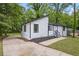 Home exterior view with sloped roof and black trim surrounded by mature shade trees at 9438 Cedar Creek Pl, Douglasville, GA 30135
