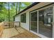 A back deck with sliding glass doors overlooks the wooded yard of this home at 9438 Cedar Creek Pl, Douglasville, GA 30135