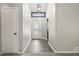 Bright foyer featuring updated flooring, an oval front door, and modern light fixtures at 9438 Cedar Creek Pl, Douglasville, GA 30135