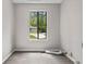 The laundry room has wood-look flooring and a window with a view of the outdoors at 9438 Cedar Creek Pl, Douglasville, GA 30135