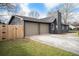 Side view of the home showcasing the two-car garage, driveway, and partial fence at 170 Gilreath Nw Rd, Cartersville, GA 30121