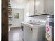 Laundry room with tile floor, built-in shelving, and washer and dryer at 170 Gilreath Nw Rd, Cartersville, GA 30121