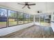 Bright sunroom features an abundance of windows, wood flooring, and ceiling fans at 170 Gilreath Nw Rd, Cartersville, GA 30121