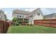 Fenced backyard featuring a lush lawn, landscaping, and a view of the rear exterior of the home at 1840 Brighton Se Blvd, Atlanta, GA 30316