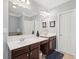 Bathroom featuring double sinks, dark wood cabinets, and large mirror at 1840 Brighton Se Blvd, Atlanta, GA 30316