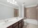 Bright bathroom with a dual sink vanity, tiled shower, and a large mirror at 1840 Brighton Se Blvd, Atlanta, GA 30316