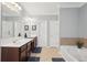 Bathroom featuring double sinks, large mirror, and garden tub at 1840 Brighton Se Blvd, Atlanta, GA 30316