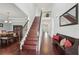 Inviting foyer with hardwood floors, staircase, and dining area featuring elegant light fixture at 1840 Brighton Se Blvd, Atlanta, GA 30316