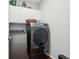 Bright laundry room with modern washer and dryer and overhead storage at 1840 Brighton Se Blvd, Atlanta, GA 30316