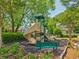 Community playground equipped with various play structures, green seating and bordered with flowering plants at 1840 Brighton Se Blvd, Atlanta, GA 30316