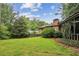 Spacious backyard with green lawn and mature trees, perfect for outdoor activities at 2700 Regency E Dr, Tucker, GA 30084