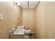 Cozy half bathroom featuring neutral wallpaper and classic fixtures for a functional and inviting space at 2700 Regency E Dr, Tucker, GA 30084