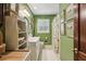 Bathroom with white vanity, patterned shower curtain, and charming green paint at 2700 Regency E Dr, Tucker, GA 30084