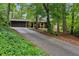 Charming home nestled in a wooded lot featuring a long driveway and brick facade at 2700 Regency E Dr, Tucker, GA 30084